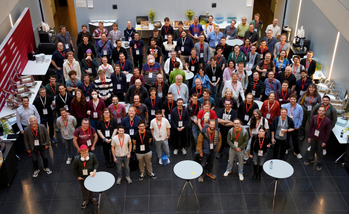 Group photo of Open Transport Community Conference 2026 attendees, standing in the foyer of the SBB headquarters.